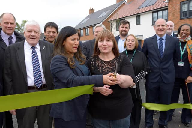 Cllr Simy Dhyani and tenant Linda James cut the ribbon at the official opening of the Wilstone development. Image submitted .