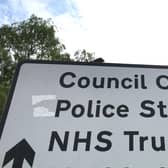A sign for council offices, police station and NHS Trust in Borehamwood, Hertfordshire. Credit: Will Durrant/LDRS