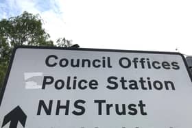 A sign for council offices, police station and NHS Trust in Borehamwood, Hertfordshire. Credit: Will Durrant/LDRS