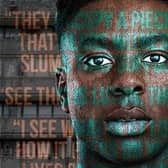 Actor Olatunji Ayofe stood in front of council flats with play quotes over his face.