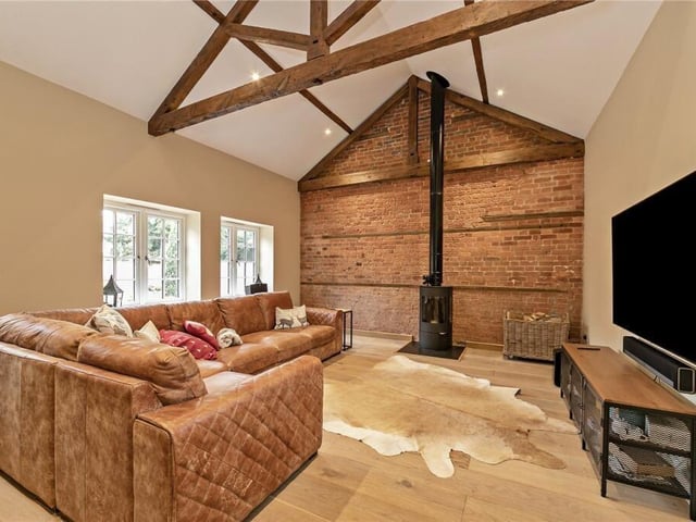 The second wing houses a study with a door leading onto the courtyard. And as if there wasn't enough space in the huge kitchen, there is also aTV room with exposed brickwork and a log burner. So no more fighting over who gets to control the remote.