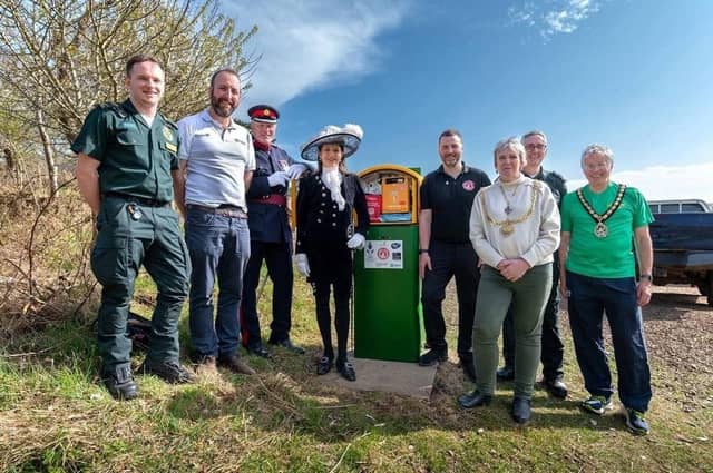 Dignitaries unveiling solar powered defibrillator