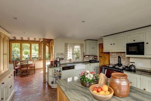 The kitchen has handmade Shaker-style units, an oil-fired Aga and a large central island.