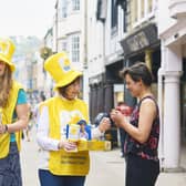 Volunteers collecting for the Great Daffodil Appeal 2018. The person donating is Miriam Strong. Photo from Ben Gold