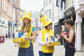 Volunteers collecting for the Great Daffodil Appeal 2018. The person donating is Miriam Strong. Photo from Ben Gold