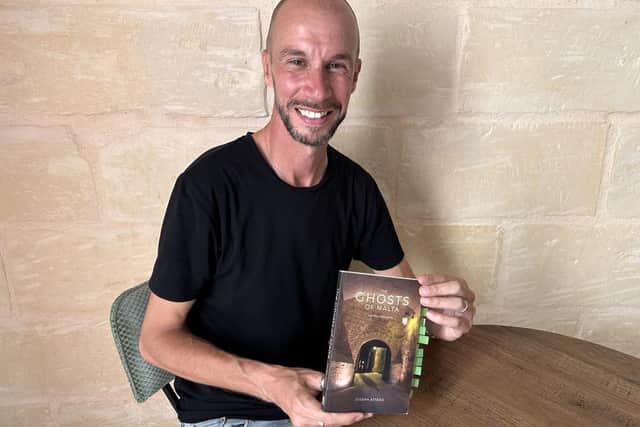 Tour guide Mario with the book containing the account of Bill McGregor's discovery.