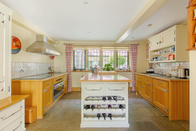 Wine racks, views of the gardens and an island - this kitchen has it all