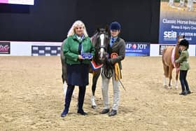 Maisie receiving her prize from show organiser Nicolina MacKenzie
