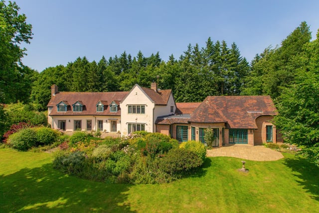 The house looks onto landscaped gardens in the countryside