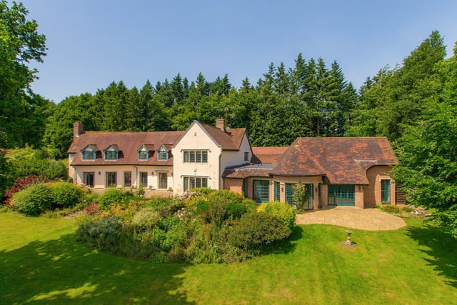 The house looks onto landscaped gardens in the countryside