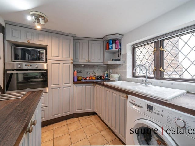 The kitchen area includes integrated amenities with wood-effect surfaces giving it a rustic finish.