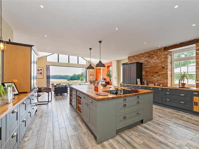 Here is the luxuriously large kitchen, with an enormous island. Everything is integrated and has an induction hob to cook up a storm.