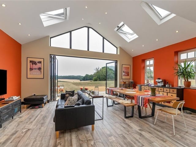 At the back of the kitchen is a dining table and a cosy TV area!