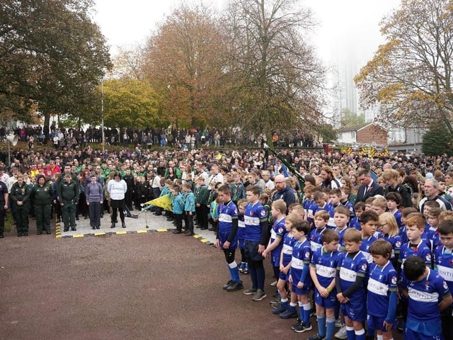 People at the parade bowed their heads for the two-minute silence