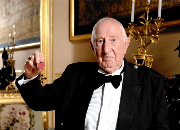 Bob pictured receiving his OBE.