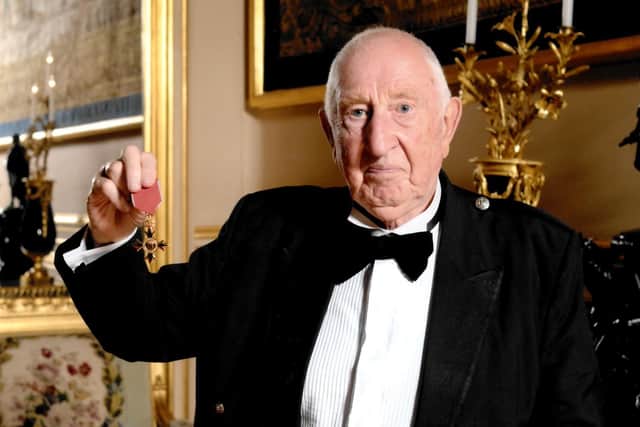 Bob pictured receiving his OBE.
