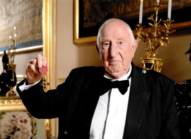 Bob pictured receiving his OBE.