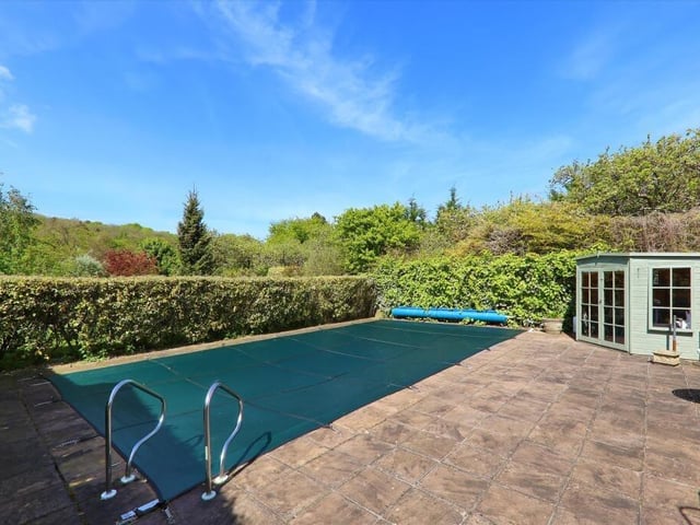 In the bottom corner of the gardens, behind mature hedging, is the open air swimming pool that is heated and has a paved surround and summer house.