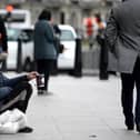 Pictured: Homeless man sitting on a road