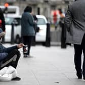 Pictured: Homeless man sitting on a road