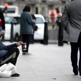 Pictured: Homeless man sitting on a road