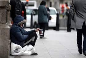 Pictured: Homeless man sitting on a road