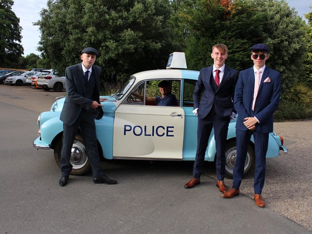 Three teenagers came to the prom in a vintage police car, wearing flat caps.