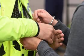 An individual being handcuffed. Photo from Joe Giddens/PA Images