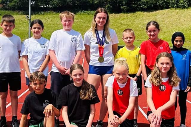 Team GB’S U18 Gold Medallist Mia McIntosh with children from Aspire.