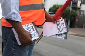 An RMT union campaigner hands out leaflets opposing ticket office cuts in Cheshunt, Hertfordshire. Credit: Will Durrant/LDRS