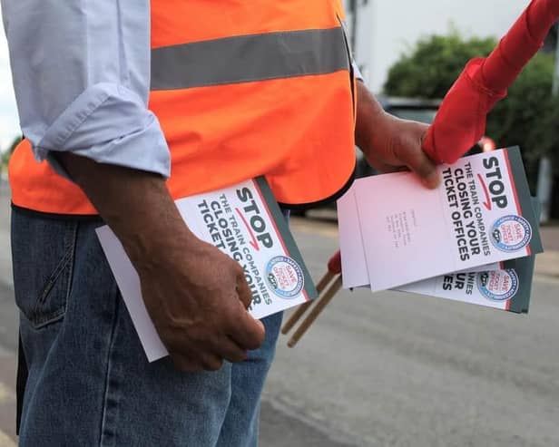 An RMT union campaigner hands out leaflets opposing ticket office cuts in Cheshunt, Hertfordshire. Credit: Will Durrant/LDRS