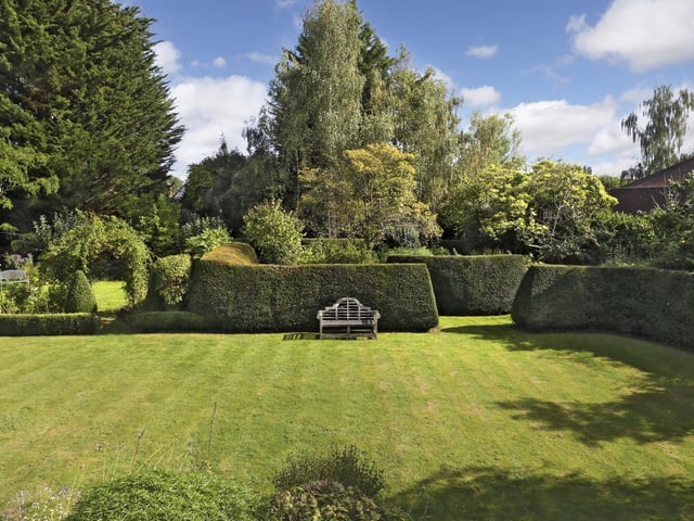 The large gardens have been thoughtfully designed with areas of lawn and hidden walkways and secret garden rooms.