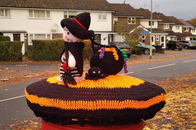 A post box is now home to a little witch, a spider and her cauldron