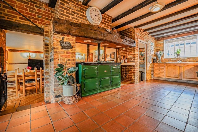 The rustic-style kitchen comes with a four-oven aga, a walk-in pantry and steps leading to a breakfast room.