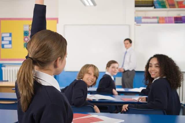 A girl raising her hand in a classroom