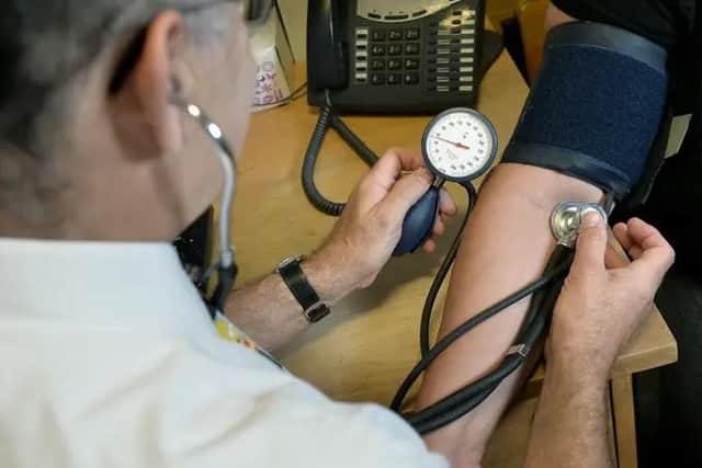 Pictured: GP with patient