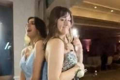 Dressed in their gowns, the girls smiled in the booth.