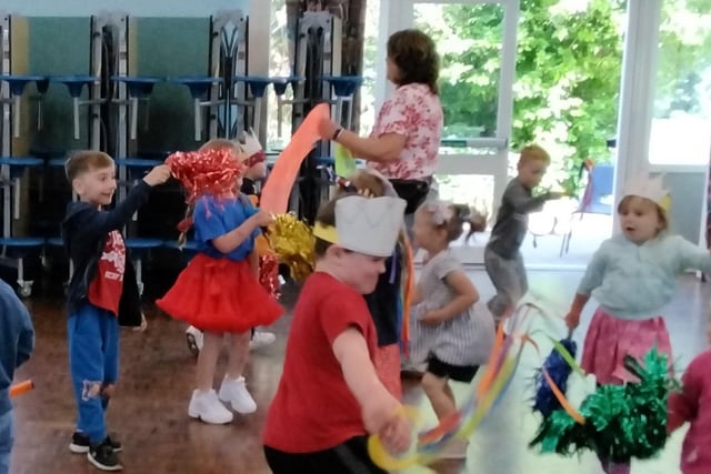 The children and staff, waring red, white and blue, joined in with some morris dancing in the school hall.