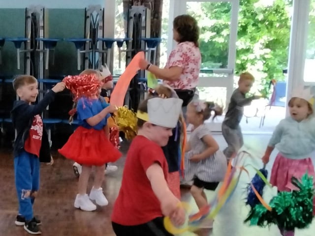 The children and staff, waring red, white and blue, joined in with some morris dancing in the school hall.
