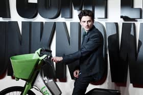 Hollywood star Timothée Chalamet turned heads by arriving to the London premiere of A Complete Unknown on a rented e-bike. (Photo by BENJAMIN CREMEL / AFP) (Photo by BENJAMIN CREMEL/AFP via Getty Images)
