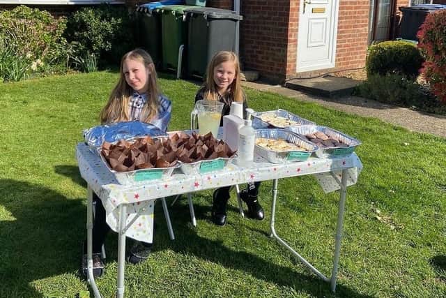 Lilia and Katie at their cake stall selling goods for Ukraine.