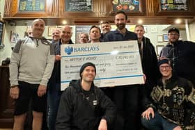 Sam from Tring Brewery (centre-right, holding cheque) presents a cheque for £10,142.60 to Robert Stringer (left-centre, Hector’s father and charity founder + trustee) and Dec (front-centre, charity campaigns and events assistant) from Hector’s House, flanked by members of Hector’s House ‘Gentle-man’s Club’.