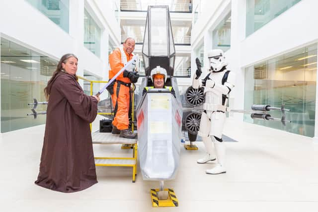 fancy dress pros alongside the full-size replica fighter jet