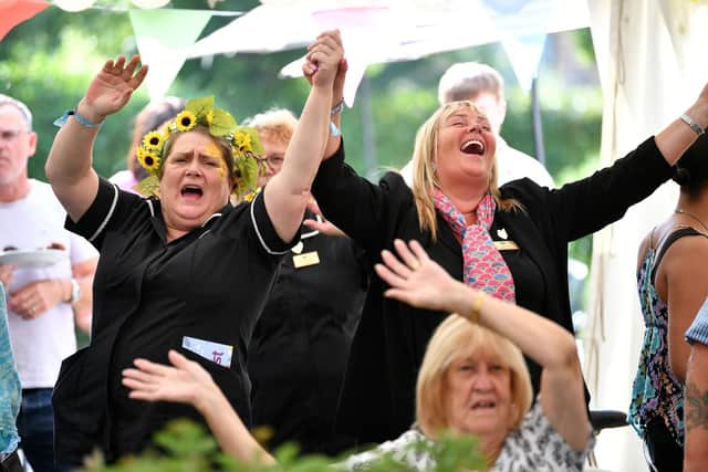 Team members and residents join in the singing and dancing to Queen tribute act