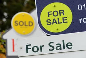 General view of Sold and For Sale signs outside a block of flats