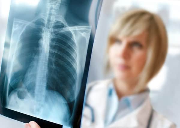 QA Hospital has been criticised in a report after thousands of patents did not have chest X-rays reviewed by an expertly-trained clinician