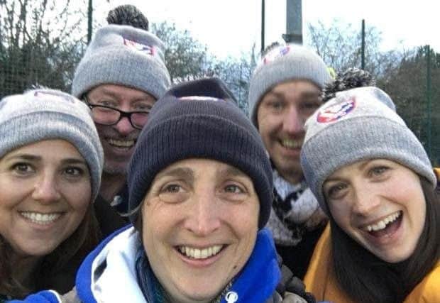 Berkhamsted and Hemel Hempstead Hockey Club ladies 2nd team supporters wrapped up against the elements.