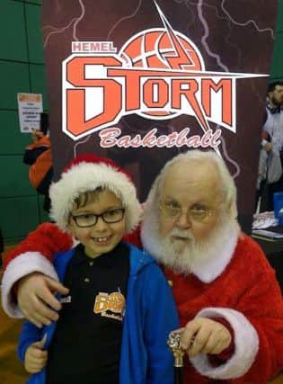 Father Christmas with Storm fan Miles Nouch at Saturdays game. Santa collected some donations for the Hospice of St Francis. (Pic: Lin Titmuss)