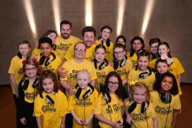 Evan Ball (pictured middle row third from right) with the Rays of Sunshine choir and stage stars Michael Ball and Alfie Boe