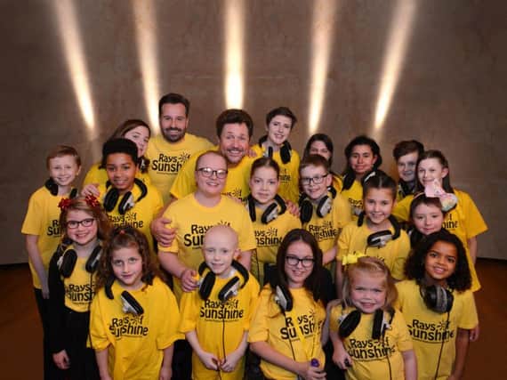 Evan Ball (pictured middle row third from right) with the Rays of Sunshine choir and stage stars Michael Ball and Alfie Boe